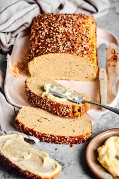 sliced loaf of bread with cream cheese spread on top