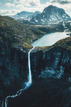 an aerial view of a waterfall in the mountains