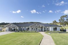 a house in the middle of a grassy field