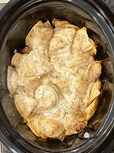 a crock pot filled with food sitting on top of a table