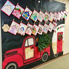 a decorated bulletin board with pictures on it and christmas decorations hanging from the back wall