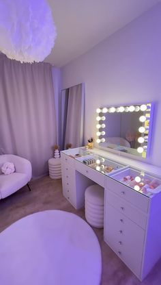 a room with a vanity, chair and mirror in it that has lights on the walls