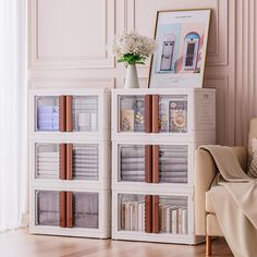 a living room with a couch, chair and bookshelf on the floor in front of a pink wall