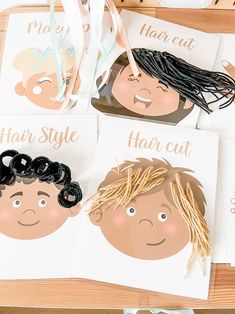 four children's hair cut cards on a table