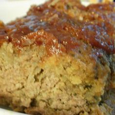 a piece of meatloaf on a plate with ketchup