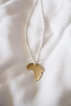 This little necklace needs no explanation – I love my continent!If you live in Africa or have travelled to Africa, then this luxurious gold Lola&Cash creation is for you - Handmade with love in Africa!If you have another State, Country or Continent in mind, maybe an Island, I can make most shapes, and the price will be the same - so let me know where your heart lies.— d e t a i l s —-plain Africa pendant measures 2cm tall-hand sawn from solid 9ct yellow gold-includes a complimentary 45cm sil Engraved Pendant Necklace Souvenir, Gold Pendant Necklace As Souvenir, Yellow Gold Pendant Jewelry Souvenir, Yellow Gold Pendant Jewelry For Souvenir, Yellow Gold Pendant Necklace As Souvenir, Yellow Gold Pendant Jewelry As Souvenir, Gold Necklace With Large Pendant In Recycled Gold, Gold Engraved Jewelry Souvenir, Engraved Gold Jewelry As Souvenir