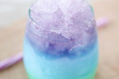 a blue and purple drink sitting on top of a table