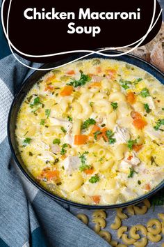 chicken macaroni soup in a black bowl with bread on the side