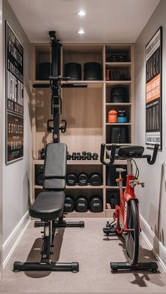 a home gym with an exercise bike in the corner and other equipment on shelves behind it