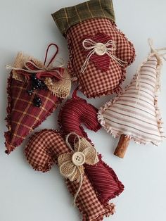 four pieces of fabric are sitting on the table together, one is red and white