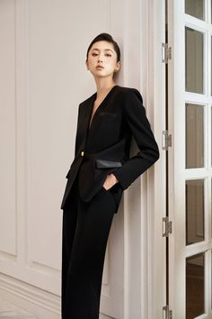 Expertly designed for a sleek and sophisticated look, this blazer is a timeless addition to any wardrobe. The structured lapelless design exudes confidence and professionalism, while the high-quality gabardine fabric ensures durability and comfort. Elevate your style with this versatile and elegant blazer. *Note: The length is measured from the shoulder to the shortest of the front. Chic Evening Blazer With Lapel Collar, Elegant Evening Pantsuit For Fall, Semi-formal Suits With Structured Shoulders, Luxury Long Sleeve Formal Pantsuit, Semi-formal Suits With Structured Shoulders And Suit Collar, Luxury Long Sleeve Tuxedo For Office, Tailored Sleek Blazer Dress For Business, Sleek Tailored Blazer Dress For Business, Luxury Fall Formal Pantsuit