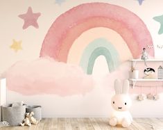 a child's room decorated in pastel colors with a rainbow painted on the wall