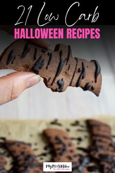 a hand holding a cookie with chocolate frosting on it and the words, 21 low carb halloween recipes