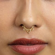 a woman's nose with a gold nose ring