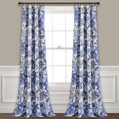 the blue and white curtains are hanging in front of a window with an open curtain