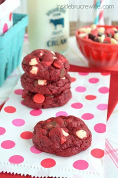 red velvet cookies stacked on top of each other with pink and white polka dot paper