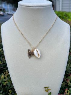 Elevate your accessory game with this oceanic necklace, showcasing a unique shark tooth and authentic cowrie shell. This handcrafted masterpiece offers a harmonious blend of luxury and natural history, ideal for those who treasure the ocean's natural beauty and seek a touch of coastal style in their look.  The gold chain measures a length of 18" and length is is adjustable to 17" & 16".  Each shark tooth is a natural relic that has been preserved for millennia, now presented in a modern setting for the contemporary wearer. Please note that the images serve as representations of the type of jewelry you'll receive. Keep in mind that each shark tooth will vary in both color and size, reflecting their natural diversity and unaltered characteristics. Shark Tooth Necklace, Tooth Necklace, Saint Augustine, Shark Tooth, Shark Teeth, Cowrie Shell, Coastal Style, Natural History, Gold Chain