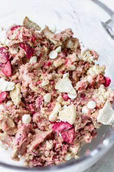 a close up of a bowl of food with nuts and other things in the bowl