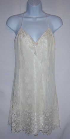 "Vintage Flora Nikrooz ivory satin and lace bridal or honeymoon teddy nightgown, negligee, peignoir or gown. Deadstock. Never worn. Original tags still attached. Women's size LARGE. 100% polyester. Measurements: bust-40\", length-37\", waist-32\". All lace body with satin lining. Gorgeous lace hem." V-neck Lace Trim Nightgown For Wedding, Satin Nightgown With Delicate Lace For Wedding, Elegant White Nightgown With Bias Cut, Satin Wedding Nightgown With Lace Trim, V-neck Bias Cut Nightgown For Wedding, Satin Wedding Nightgown With Delicate Lace, Wedding Nightgown With Delicate Lace And Satin, Wedding Satin Nightgown With Lace Trim, V-neck Wedding Nightgown With Bias Cut