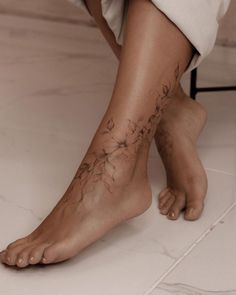 a woman's foot with flowers on it