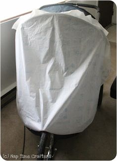 a bike covered with a white sheet in a room