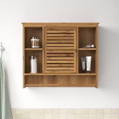 a bathroom with a wooden shelf above the bathtub and towels hanging on the wall