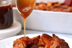 a spoon drizzling caramel sauce onto some bread