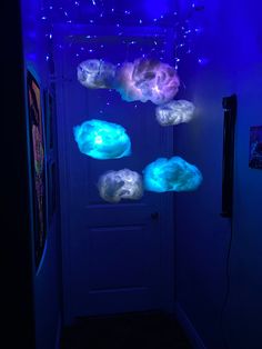 the door is lit up with blue lights and some clouds floating from it's ceiling