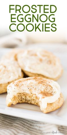 two eggnog cookies on a white plate with the words frosted eggnog cookies