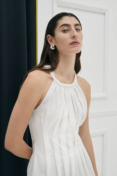 The Lucania halter dress in 100% Cotton is uniquely tapered at the waist with shaped box pleats giving the dress a flattering silhouette. The dress also has an invisible zipper and side pockets for ease of wear. Colour: Ivory Fit: Semi fitted silhouette (fitted at waist). Model is wearing a Size AU 8 Box Pleated Dress, Fashion Study, Black Dress Style, Garment Care Labels, 20s Fashion, Halter Maxi Dresses, Long Black Dress, Summer Design, Box Pleats