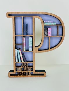 the letter p is made out of wood and has bookshelves on each side