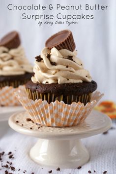 chocolate cupcakes with white frosting and oreo cookies on top