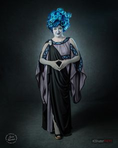 a woman with blue hair wearing a black dress