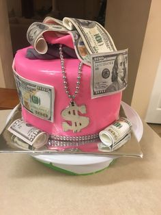 a pink cake with money on top