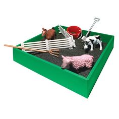 a toy farm scene with animals and tools