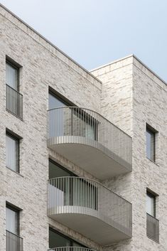 an apartment building with balconies on the second floor