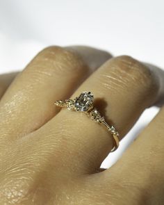 a woman's hand with a diamond ring on it