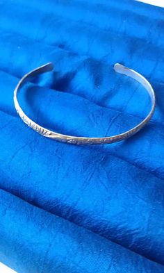 Sterling silver cuff bracelet made with a (floral) pattern wire, just under 3/16 inch (4mm) wide. Specify size, small-5 inch, fits about 6 inch wrist, medium-5 & 1/2 inch, fits about 6 & 1/2 inch wrist, or large-6 inch, fits about 7 inch wrist. Shipped in a gift box to protect during shipment. Adjustable Silver Etched Cuff Bracelet, Adjustable Etched Silver Cuff Bracelet, Adjustable Silver Etched Bangle, Adjustable Etched Silver Bangle, Adjustable Silver Stamped Bangle, Adjustable Stamped Sterling Silver Bangle, Adjustable Stamped Silver Bangle, Adjustable Etched Metal Cuff Bracelet, Silver Hypoallergenic Cuff Bangle Bracelet