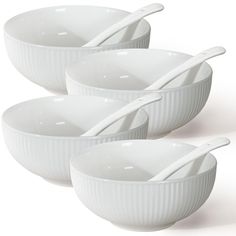 three white bowls with spoons in them