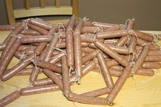 a pile of sausages sitting on top of a wooden table