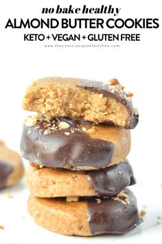 chocolate covered almond butter cookies stacked on top of each other