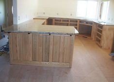 an empty kitchen with wooden cabinets and marble counter tops in the process of remodeling