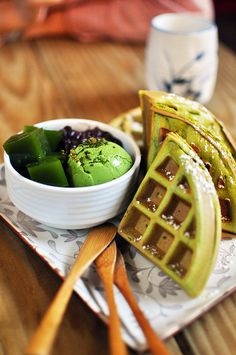 waffles and green tea on a plate with chopsticks next to them