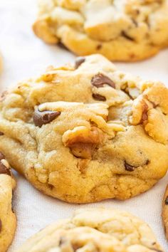 chocolate chip cookies are lined up on a baking sheet