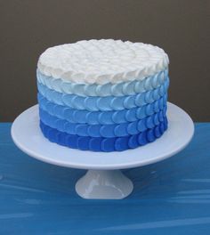 a blue and white cake sitting on top of a table