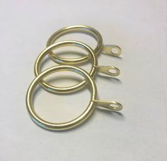 four metal rings on a white surface