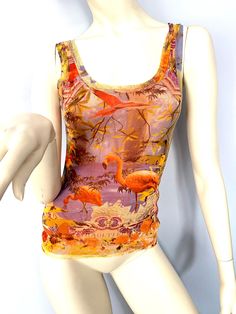 Jean Paul Gaultier S/S 1999 flamingo and parrot tropical print tank top made of a double layer of semi sheer mesh. Signature back tab. Brand is Jean Paul Gaultier Soleil, made in Italy by Fuzzi. Size XS but the super stretchy fabric can fit a variety of sizes. Mannequin is a smallish medium or French 38. 100% Nylon/Polyamide semi sheer, stretchy mesh fabric. In excellent condition.  MEASUREMENTS: (taken flat, across and unstretched). Because there is so much stretch in this fabric it can fit man Multicolor Mesh Top For Summer, Sheer Mesh Tank Top For Summer, Fit Man, Mesh Tank Top, Print Tank Top, Paul Gaultier, Print Tank, Printed Tank Tops, Jean Paul