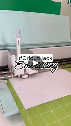 a close up of a machine cutting paper with the words cricuthack embossing on it