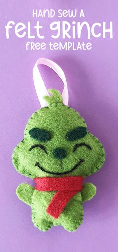 a green stuffed animal hanging on a purple background with the words hand sew a felt grin free template