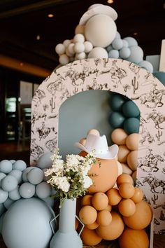 an arrangement of balloons and vases on a table